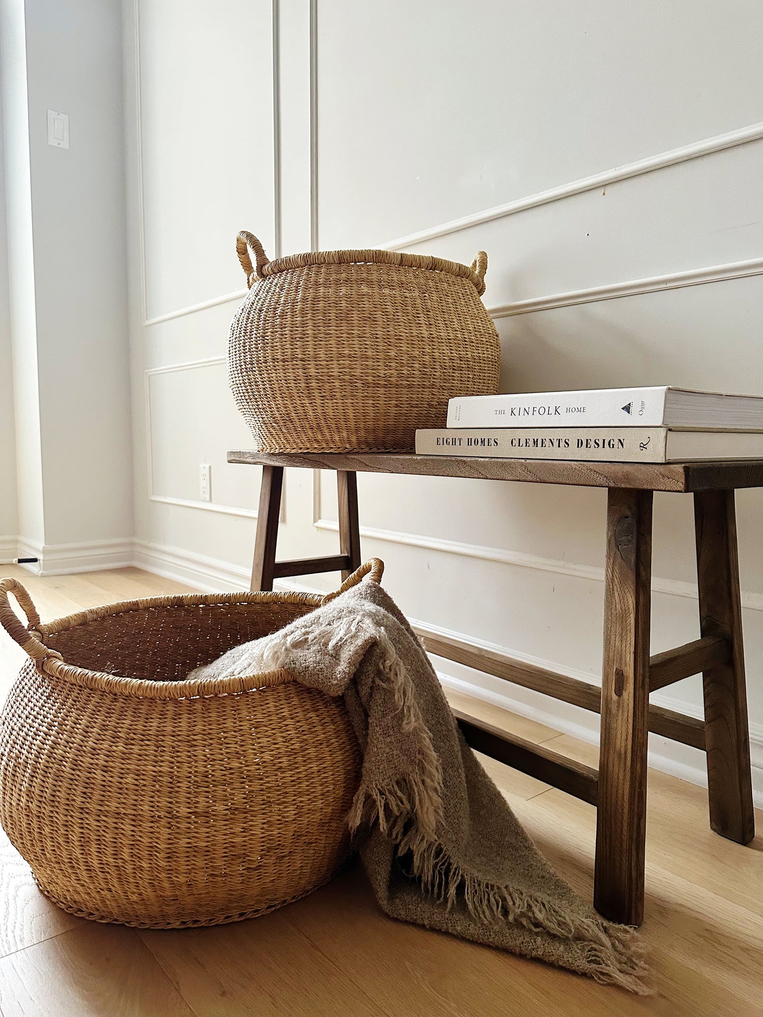 2 storage baskets with handles made with elephant grass.