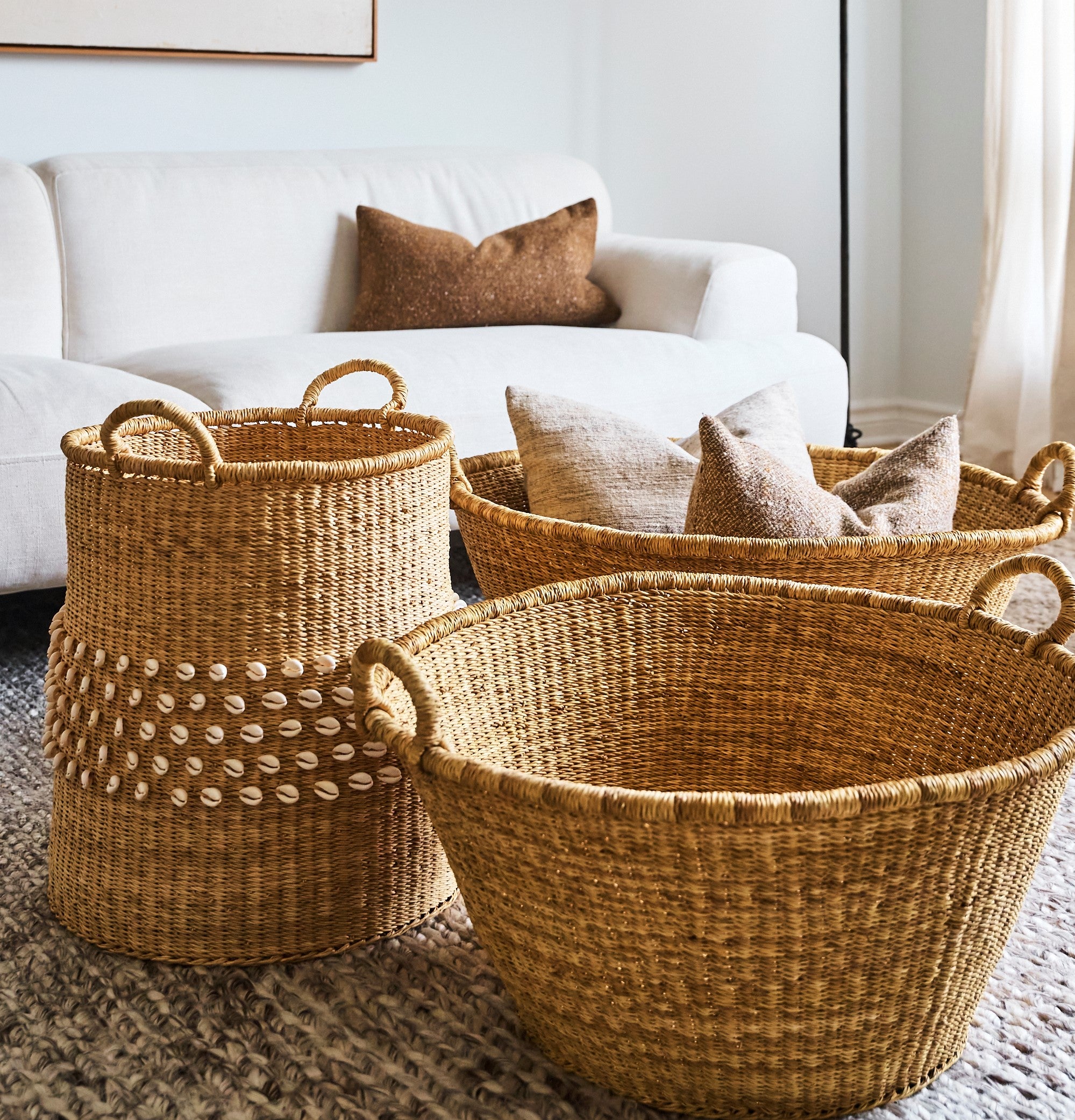 three sustainable woven baskets in a living room